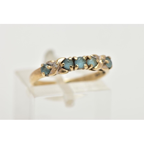 56 - A 9CT GOLD GEM SET HALF HOOP RING, designed with a row of five circular cut aquamarines, cross detai... 