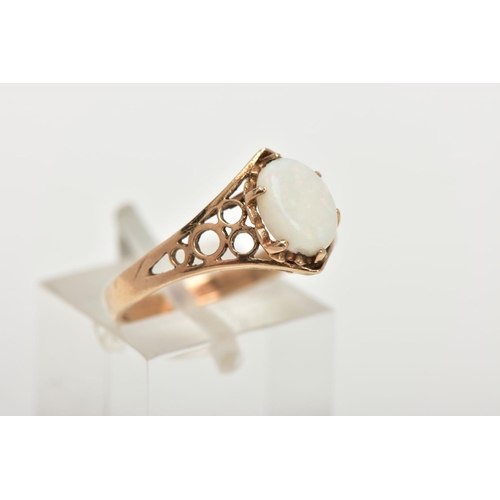 57 - A 9CT GOLD OPAL DRESS RING, set with a central oval cut opal cabochon, six claw set, openwork should... 