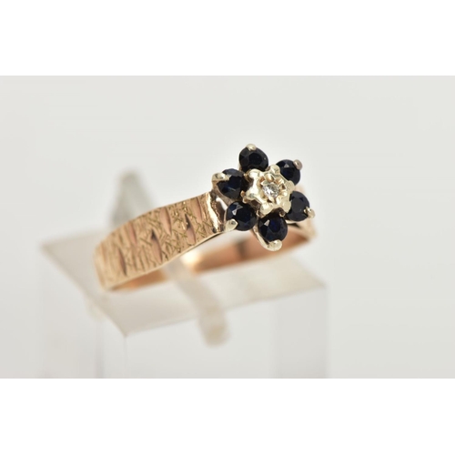 59 - A 9CT GOLD SAPPHIRE AND DIAMOND CLUSTER RING, of a flower design set with a central single cut diamo... 