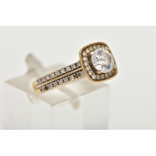 60 - A 9CT GOLD CUBIC ZIRCONIA DRESS RING, centring on a colourless circular cut cubic zirconia, within a... 