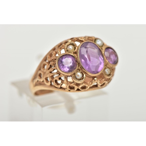 61 - A YELLOW METAL AMETHYST AND SEED PEARL DRESS RING, centring on an oval cut amethyst milgrain collet ... 