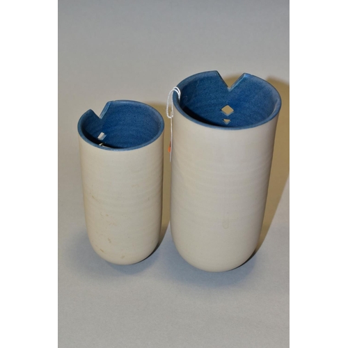 544 - TWO LOUISE DARBY (B.1959) STUDIO POTTERY CREAM AND BLUE GLAZED CYLINDRICAL VASES, V shaped cut away ... 