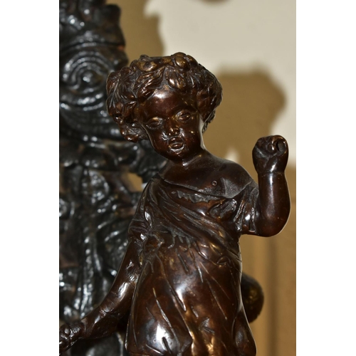 564 - A 20TH CENTURY BRONZE FIGURE OF A PUTTI AND A CAST IRON MR PUNCH DOORSTOP, the bronze cast wearing a... 