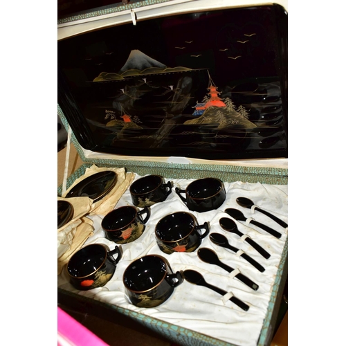 585 - A BOXED BLACK LACQUER TEA SET comprising a mid-20th Century lacquer tea set in a fitted case, six cu... 