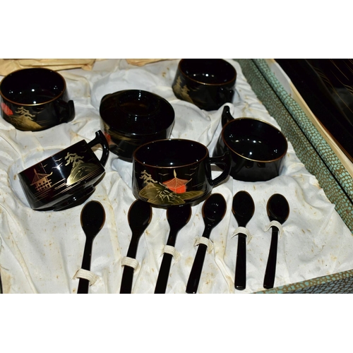 585 - A BOXED BLACK LACQUER TEA SET comprising a mid-20th Century lacquer tea set in a fitted case, six cu... 