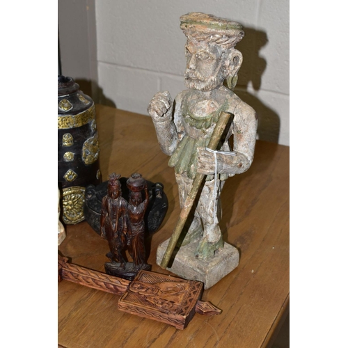 625 - A GROUP OF INTERNATIONAL WOODEN AND METAL ITEMS, comprising a carved wooden figure of a man height 3... 