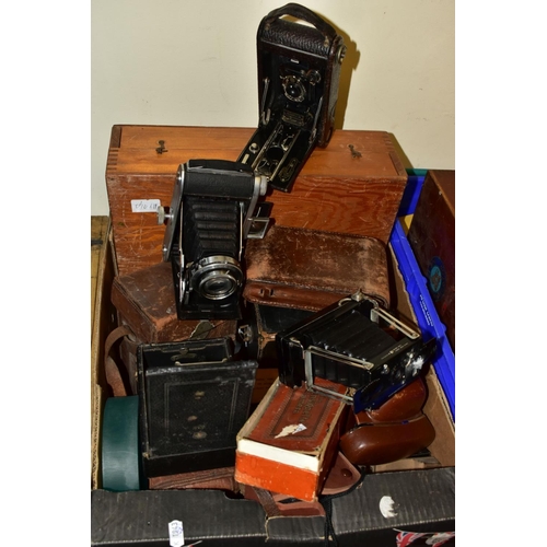 675 - SEVEN BOXES OF ANTIQUE AND VINTAGE CAMERAS, to include a Zeiss Ikon sheet film camera with Compur sh... 