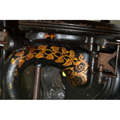 792 - THREE VICTORIAN CAST IRON SEWING MACHINES, hand cranked mechanism, with gilt or painted decoration o... 