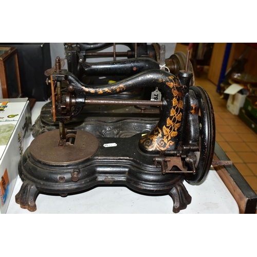 792 - THREE VICTORIAN CAST IRON SEWING MACHINES, hand cranked mechanism, with gilt or painted decoration o... 