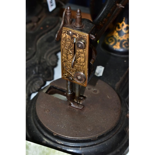 792 - THREE VICTORIAN CAST IRON SEWING MACHINES, hand cranked mechanism, with gilt or painted decoration o... 