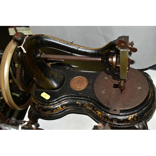 800 - THREE ANTIQUE JONES CAST IRON SEWING MACHINES, hand cranked mechanism, with gilt or painted decorati... 