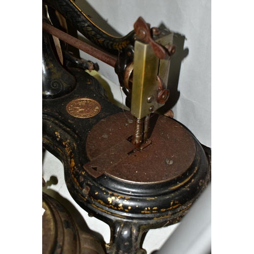 800 - THREE ANTIQUE JONES CAST IRON SEWING MACHINES, hand cranked mechanism, with gilt or painted decorati... 