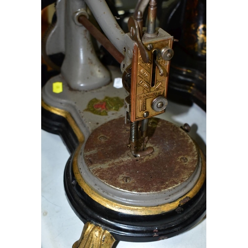 800 - THREE ANTIQUE JONES CAST IRON SEWING MACHINES, hand cranked mechanism, with gilt or painted decorati... 