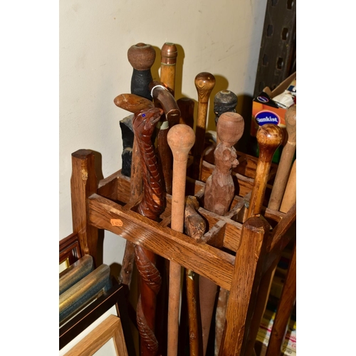 831 - A WOODEN STICK STAND AND CONTENTS, the stand with sixteen small divisions, width and depth 33.5cm he... 