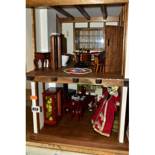 858 - A DOLLS HOUSE, exterior in Tudor style, with four rooms, hallway, stairs and landing, a two section ... 