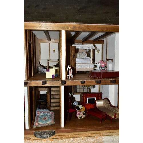 858 - A DOLLS HOUSE, exterior in Tudor style, with four rooms, hallway, stairs and landing, a two section ... 