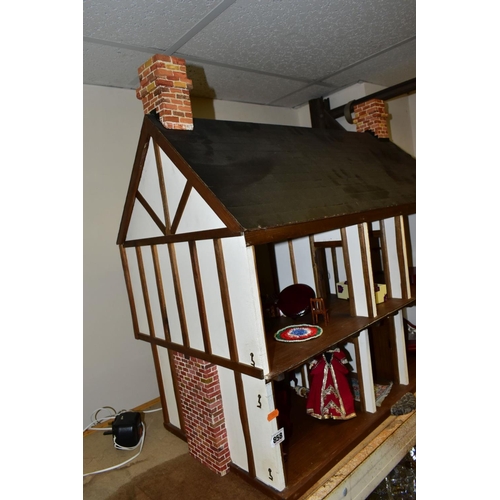 858 - A DOLLS HOUSE, exterior in Tudor style, with four rooms, hallway, stairs and landing, a two section ... 