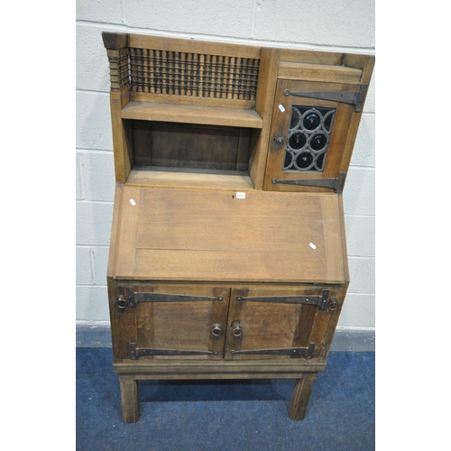 1664 - AN EARLY 20TH CENTURY OAK BUREAU, labelled Liberty & Co, in the Moorish style, the top section with ... 