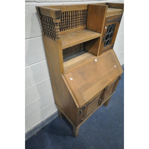 1664 - AN EARLY 20TH CENTURY OAK BUREAU, labelled Liberty & Co, in the Moorish style, the top section with ... 