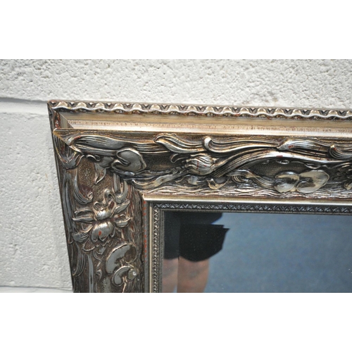1518 - A LARGE RECTANGULAR SILVERED GILT WOOD BEVELLED EDGE WALL MIRROR, with carved foliate detail, length... 