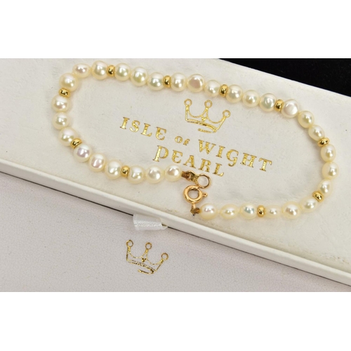 112 - A CULTURED PEARL BRACELET, cultured white button pearls every three pearls interspaced with a yellow... 