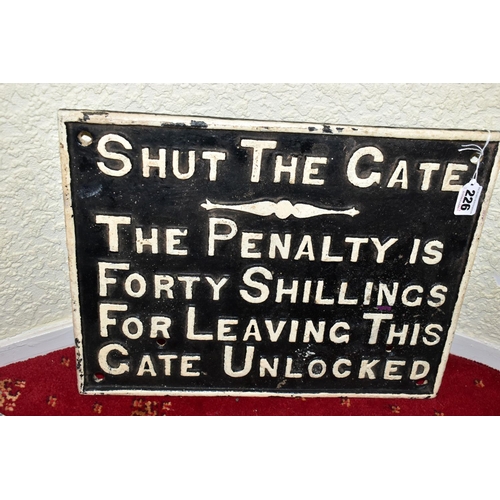 226 - A CAST IRON SHUT THE GATE PENALTY NOTICE, raised white lettering and edge surround on black backgrou... 