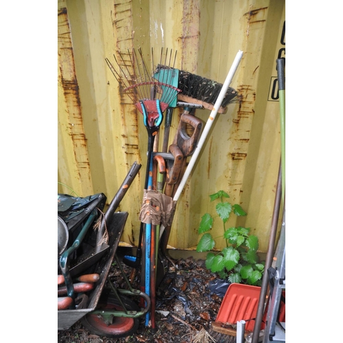 1211 - THREE GLAZED PLANT POTS AND A WHEELBARROW containing a quantity of garden tools