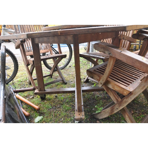 1217 - AN OCTAGONAL HARDWOOD GARDEN TABLE width 122cm with a Parasol, lazy susan and four folding chairs (4... 