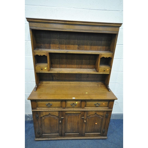 A REPRODUCTION OAK DRESSER, plate rack with two shelves, two pigeon ...