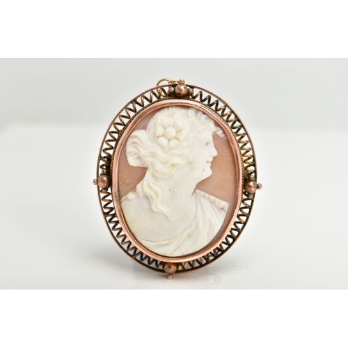 106 - A YELLOW METAL CAMEO BROOCH, of an oval form, depicting a lady in profile with a flower in her hair,... 