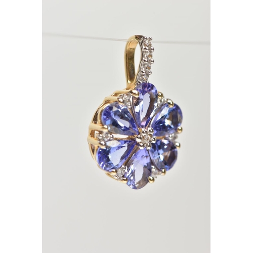 115 - A YELLOW METAL TANZANITE AND SPINEL FLOWER PENDANT, set with six pear cut tanzanite's with colourles... 