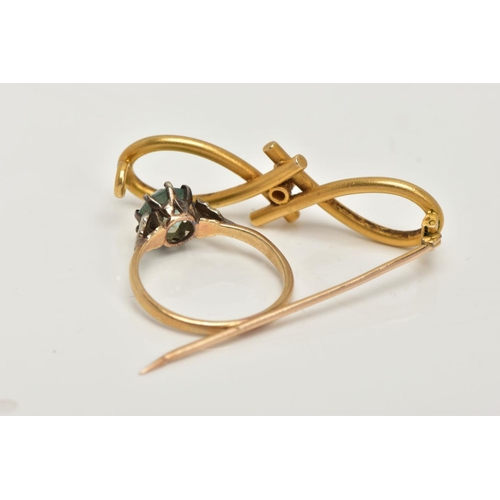 123 - A YELLOW METAL DIAMOND SET BROOCH AND A RING, the brooch of an open work infinity design set with a ... 