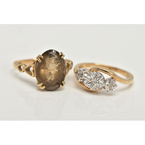 23 - TWO 9CT GOLD RINGS, an oval cut stone assessed as Smokey quartz, prong set in a yellow gold, leading... 