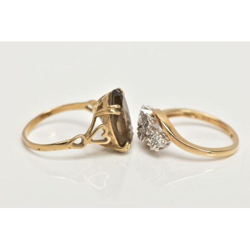 23 - TWO 9CT GOLD RINGS, an oval cut stone assessed as Smokey quartz, prong set in a yellow gold, leading... 