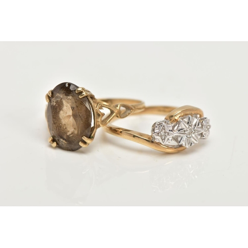 23 - TWO 9CT GOLD RINGS, an oval cut stone assessed as Smokey quartz, prong set in a yellow gold, leading... 