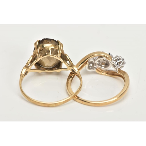 23 - TWO 9CT GOLD RINGS, an oval cut stone assessed as Smokey quartz, prong set in a yellow gold, leading... 