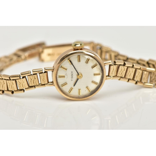 24 - A 9CT GOLD TISSOT LADIES WRISTWATCH, a hand wound movement, round champagne coloured dial signed 'Ti... 