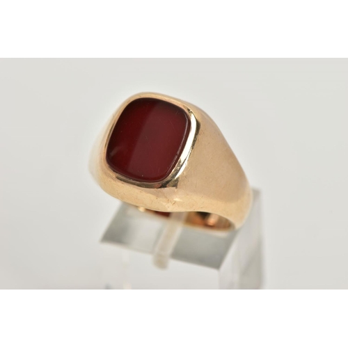 39 - A 9CT GOLD HEAVY SIGNET RING, a rounded square carnelian inlayed in a substantial yellow gold mount,... 