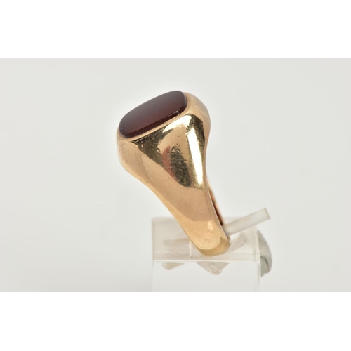 39 - A 9CT GOLD HEAVY SIGNET RING, a rounded square carnelian inlayed in a substantial yellow gold mount,... 