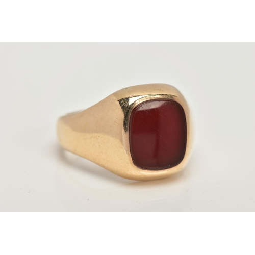 39 - A 9CT GOLD HEAVY SIGNET RING, a rounded square carnelian inlayed in a substantial yellow gold mount,... 