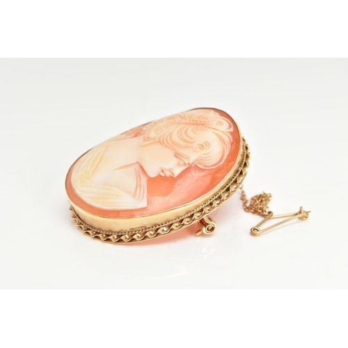 51 - A 9CT GOLD CAMEO BROOCH, an oval shell cameo depicting a lady in profile, mounted in yellow gold wit... 