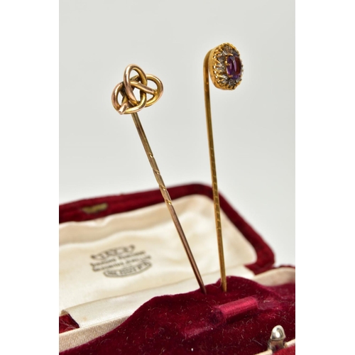 54 - TWO YELLOW METAL STICK PINS, the first detailed with an oval cluster, centring on an oval cut amethy... 