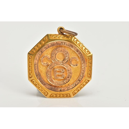 67 - AN EARLY 20TH CENTURY GOLD PENDANT, an octogen shaped medallion style pendant, detailing the letters... 