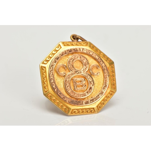 67 - AN EARLY 20TH CENTURY GOLD PENDANT, an octogen shaped medallion style pendant, detailing the letters... 