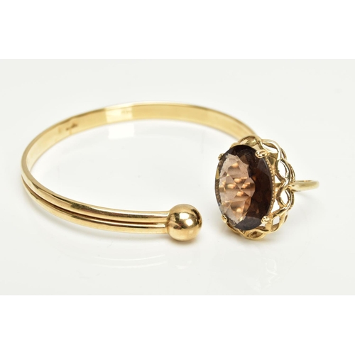 70 - A 9CT GOLD TORQUE BANGLE AND 9CT GOLD SMOKEY QUARTZ DRESS RING, a yellow gold hollow cuff bangle wit... 