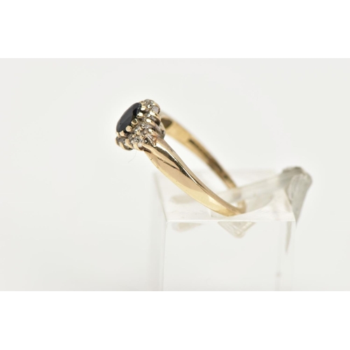 76 - A 9CT GOLD CLUSTER RING, a blue oval stone believed to be sapphire, set with a surround of round bri... 