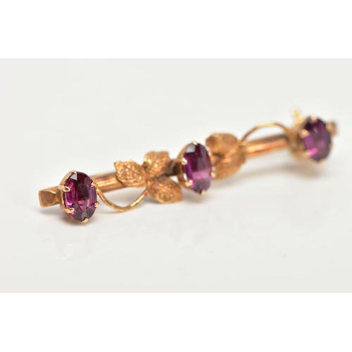 78 - A 9CT GOLD BAR BROOCH, a yellow gold foliage bar brooch, set with three oval cut pink stones, approx... 