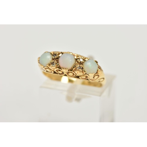 79 - AN 18CT GOLD, OPAL RING, three round oval opal stones accented with four round brilliant cut diamond... 