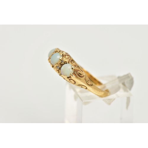 79 - AN 18CT GOLD, OPAL RING, three round oval opal stones accented with four round brilliant cut diamond... 