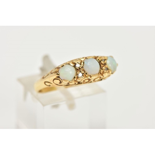 79 - AN 18CT GOLD, OPAL RING, three round oval opal stones accented with four round brilliant cut diamond... 